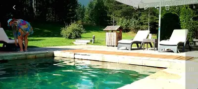 a woman standing next to a pool of water at ALL VIEW in Golf Resort in Razlog