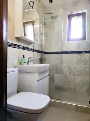 a bathroom with a toilet and a sink and a shower at Терасите - Къща 1 in Ribarica