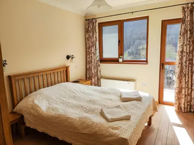 a bedroom with a bed with two towels on it at Терасите - Къща 3 in Ribarica
