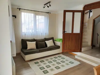 a living room with a couch and a window at Терасите - Къща 3 in Ribarica