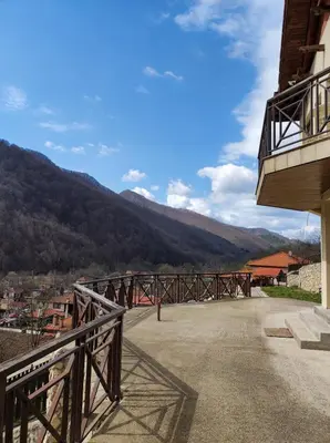 a balcony of a building with a view of a mountain at Терасите - Къща 4 in Ribarica