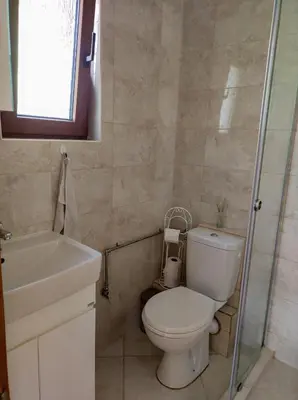 a bathroom with a toilet and a sink and a shower at Терасите - Къща 4 in Ribarica