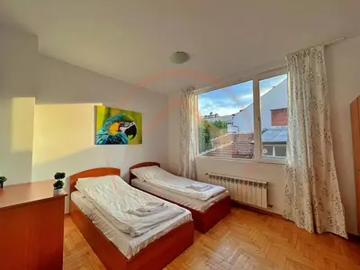 a bedroom with two beds and a large window at Tranquil Retreat in the Heart of Sofia: 2BR in Sofia