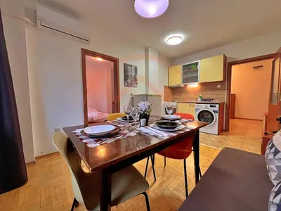 a kitchen with a table with chairs and a dining room at Tranquil Retreat in the Heart of Sofia: 2BR in Sofia