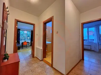 a hallway with two doors and a room with a table at Tranquil Retreat in the Heart of Sofia: 2BR in Sofia
