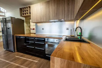a kitchen with a stainless steel refrigerator and a sink at On the top! in Sofia