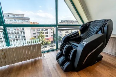 a black chair in a room with a large window at On the top! in Sofia