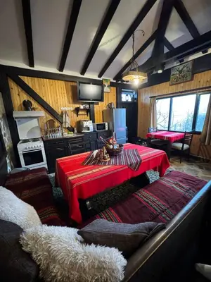 a kitchen with a red table in a room at СТАРАТА КЪЩА in Sovolyano