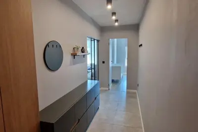 a hallway with a sink and a mirror on the wall at Mila's Cozy 1 Bedroom Apartment in Sofia
