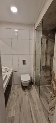 a bathroom with a toilet and a sink and a shower at Mila's Cozy 1 Bedroom Apartment in Sofia