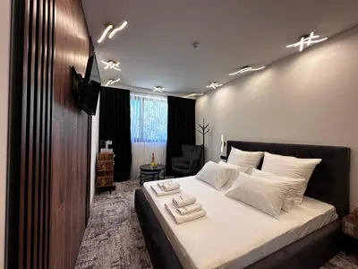 a bedroom with a large bed with white pillows at The Wind Mills Hydropark in Gorna Malina