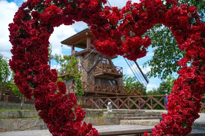 a heart made out of red flowers in front of a building at The Wind Mills Hydropark in Gorna Malina