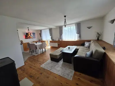 a living room with a couch and a table at Къща ВИРА in Yasă-Koriya