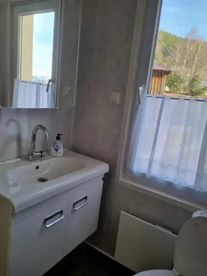 a bathroom with a sink and a window at Къща ВИРА in Yasă-Koriya