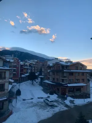 an aerial view of a city with snow covered buildings at Private Apartment Pirin Golf Club with Lake View in Razlog