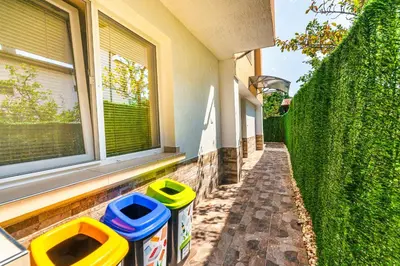 two trash cans sitting outside of a building at Sweet Home 1 in Sandanski