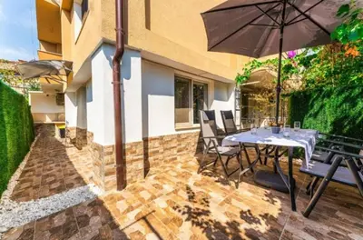 a patio with a table and an umbrella at Sweet Home 1 in Sandanski