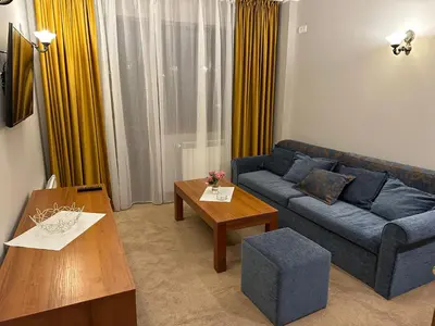 a living room with a blue couch and a table at Anna Apartment near Gondola in Bansko