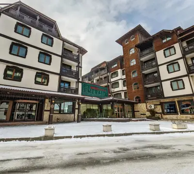 an empty street in a city with tall buildings at Anna Apartment near Gondola in Bansko