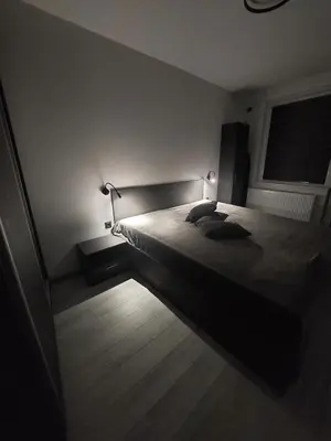 a bedroom with a bed with two pillows on it at Апартамент Слави in Blagoevgrad