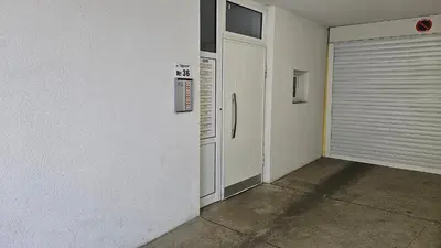 an empty garage with a refrigerator and a door at Little City Retreat in Sofia