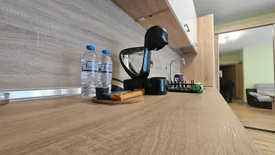 a kitchen counter with a blender and two bottles of water at Little City Retreat in Sofia