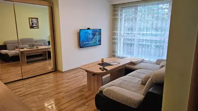 a living room with a couch and a table at Little City Retreat in Sofia