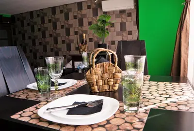 a table with plates and glasses on a green wall at The Green Apartment 2BR - free parking in Sofia