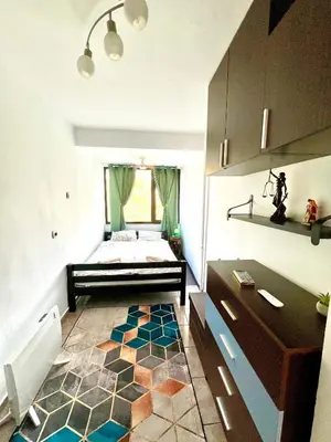 a bedroom with a bed and a rug on the floor at The Green Apartment 2BR - free parking in Sofia