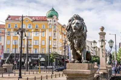 a statue of a lion in front of a building at The Green Apartment 2BR - free parking in Sofia