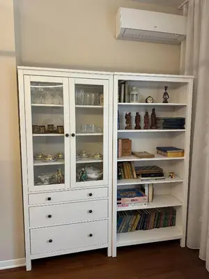 a white hutch with books in a room at Sofo house in Sofia