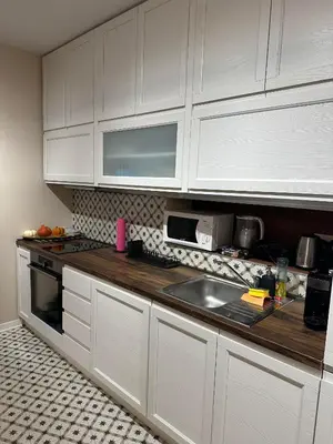 a kitchen with white cabinets and a sink at Sofo house in Sofia