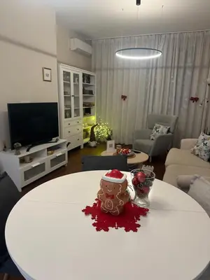 a living room with a table with a cake on it at Sofo house in Sofia