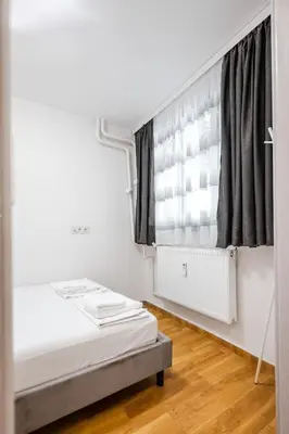 a bedroom with a bed and a window at 1BD Elegance on Vasil Levski Boulevard by Flat Mаnager in Sofia