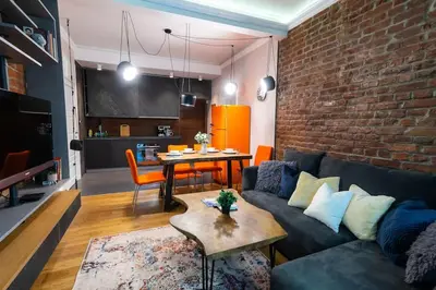 a living room with a couch and a brick wall at Top Central Design, 2 Bedroom, NDK, FREE Secured parking in Sofia