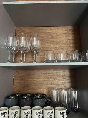 a bunch of glasses and wine glasses on a shelf at Top Central Design, 2 Bedroom, NDK, FREE Secured parking in Sofia