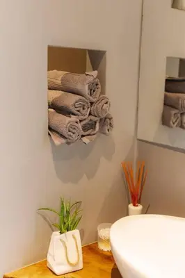 a bathroom with a pile of towels on a wall at Top Central Design, 2 Bedroom, NDK, FREE Secured parking in Sofia