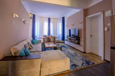a living room with a couch and a television at Top Center Relax, Vitoshka Str & NDК, FREE Parking in Sofia