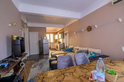 a living room with a couch and a table with a television at Top Center Relax, Vitoshka Str & NDК, FREE Parking in Sofia
