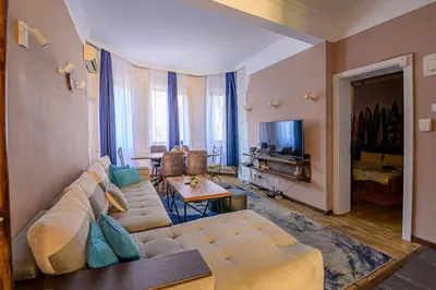 a living room with a couch and a television at Top Center Relax, Vitoshka Str & NDК, FREE Parking in Sofia