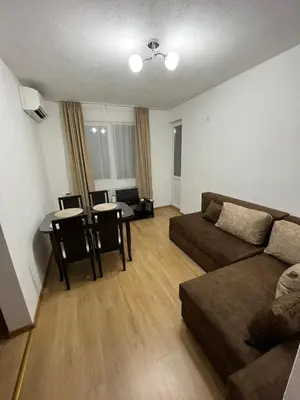 a living room with a couch and a table at Апартамент Габи in Karlovo