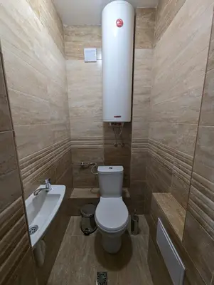 a small bathroom with a toilet and a sink at Апартамент Габи in Karlovo