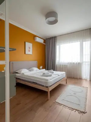 a bedroom with a bed and a yellow wall at Central Apartment Parking Two Bedrooms Sky Terrace in Sofia
