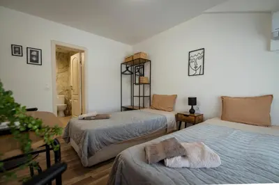 a bedroom with two beds with towels on them at Къща за гости ЕМА in Vetren Dol
