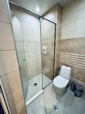 a bathroom with a toilet and a glass shower at Barbie Studio in Sofia
