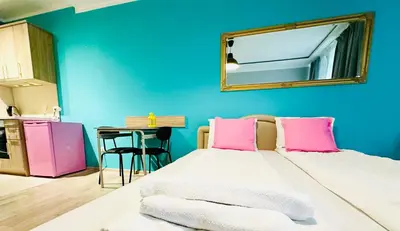 a room with two beds and a mirror on the wall at Barbie Studio in Sofia