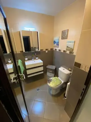 a bathroom with a toilet and a sink at Lovely 1-bedroom appartment in Sofia near Vitosha in Sofia