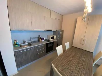 a small kitchen with a table and a microwave at Lovely 1-bedroom appartment in Sofia near Vitosha in Sofia