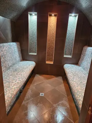 two benches in a room with two windows at Victori SPA in Dobrinishte