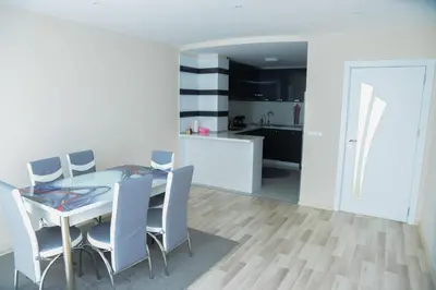 a kitchen and dining room with a table and chairs at Къща за гости Хаджиеви in Ognyanovo
